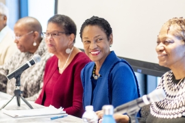 Group of people sitting at a table smiling